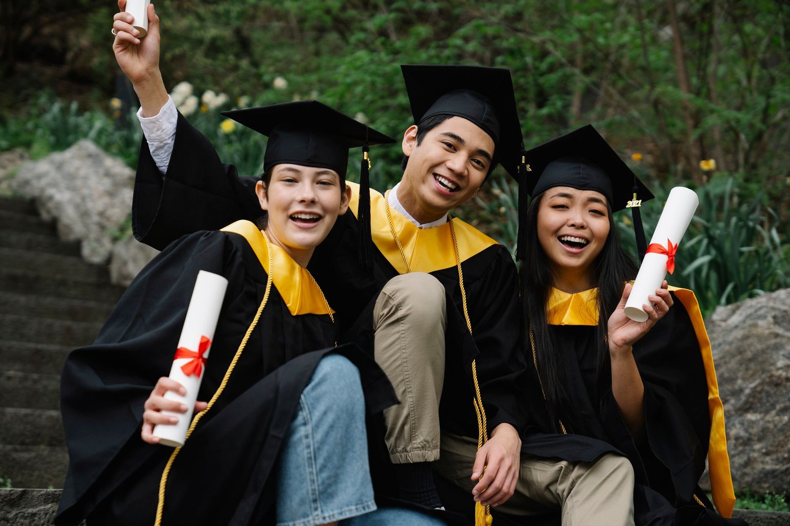 A diverse group of students celebrating graduation, symbolizing the benefits of free college education.