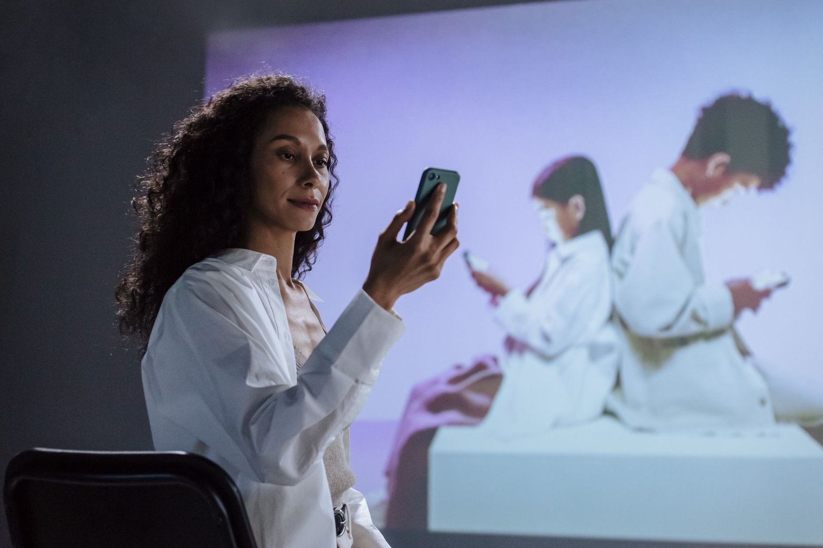A family gathered together, but each member is engaged in their own device, showing the impact of technology isolation on relationships.