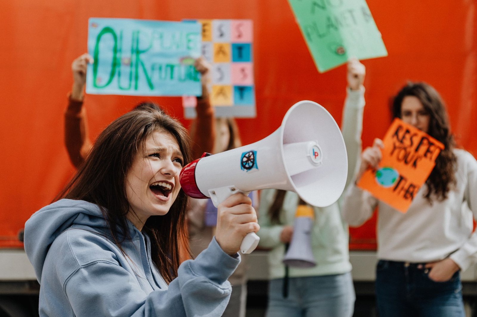 A group of Gen Z activists rallying for climate change, showcasing their signs and passion. — Gen Z political debates