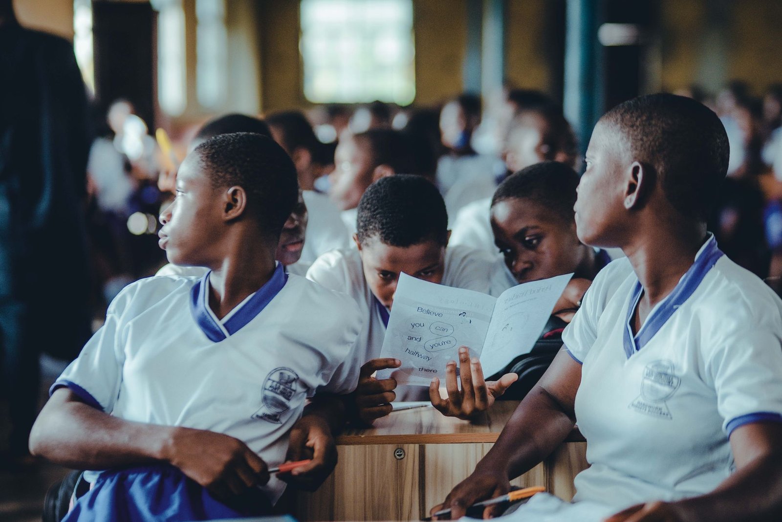 A group of parents and educators discussing school uniform policies in a meeting, reflecting community engagement. — sch…