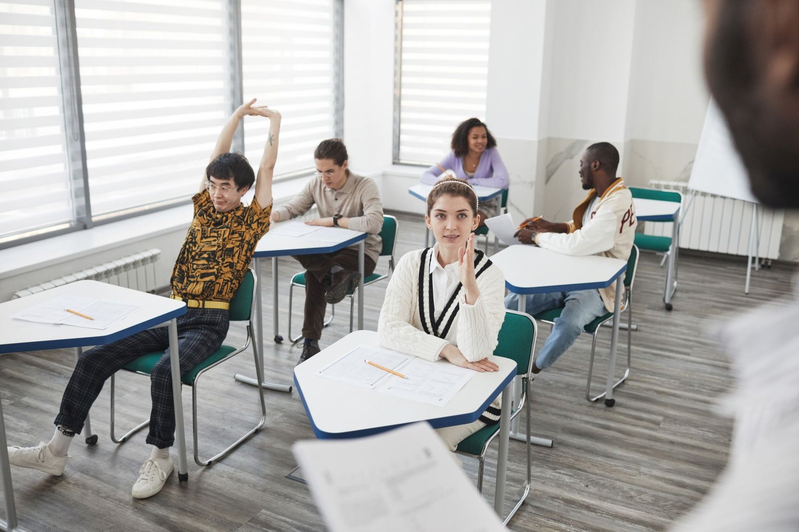 A group of peers practicing their debate skills in a classroom setting. — debate preparation