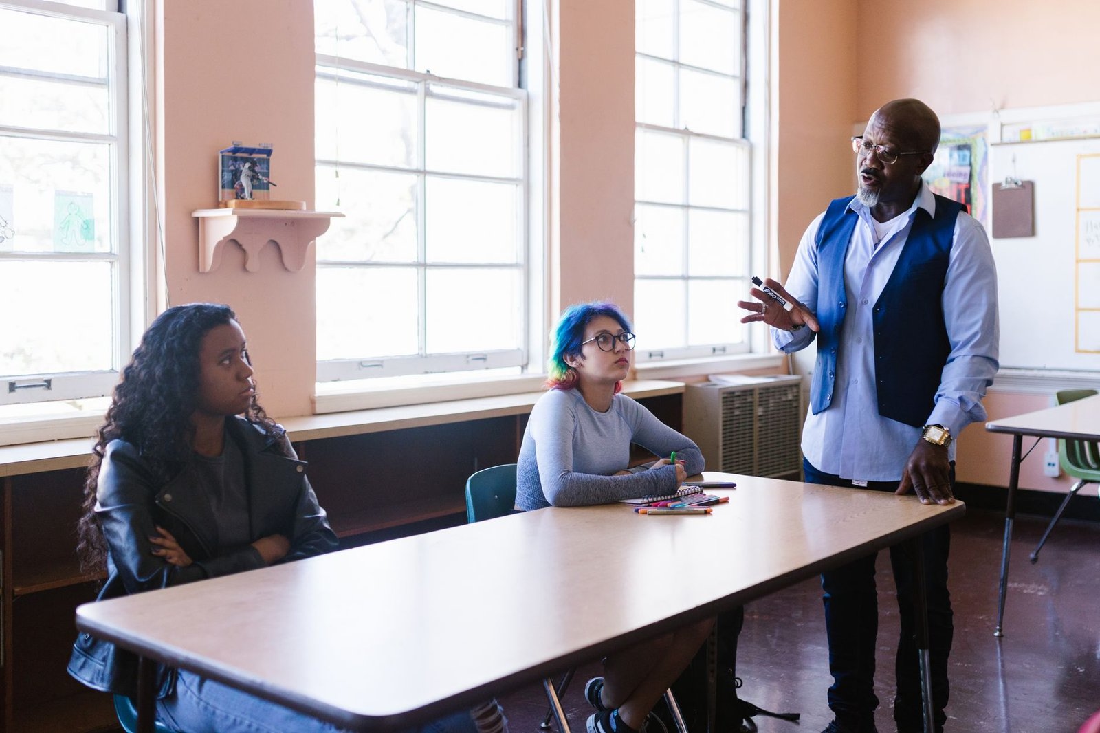 A group of students practicing a debate with a mentor providing feedback. — debate preparation