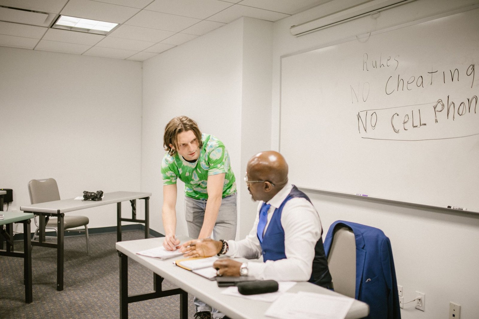 A mentor guiding a student during a debate practice session. — debate coaching