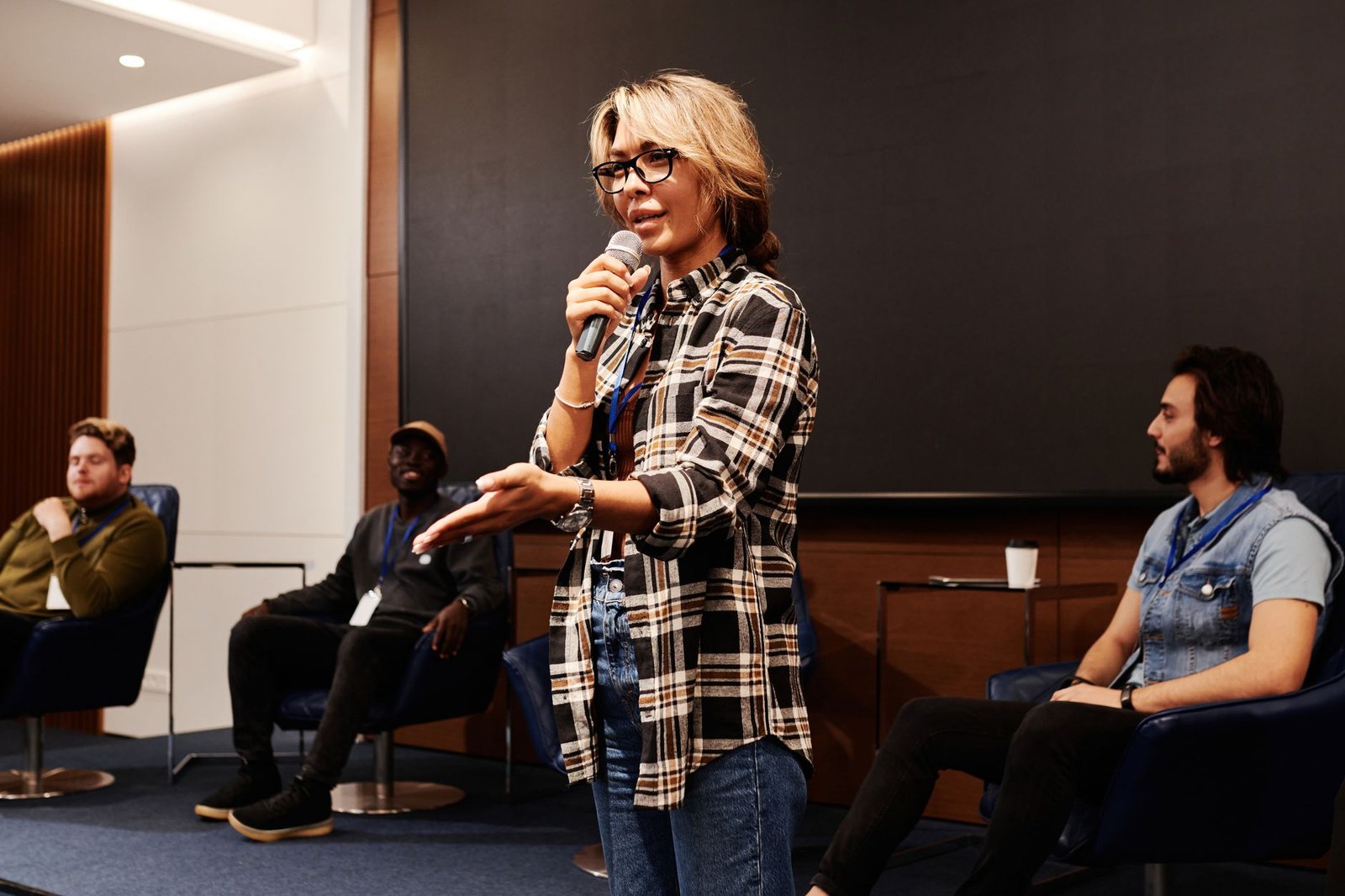 A moderator facilitating a debate, highlighting the interaction between speakers. — hosting debate night