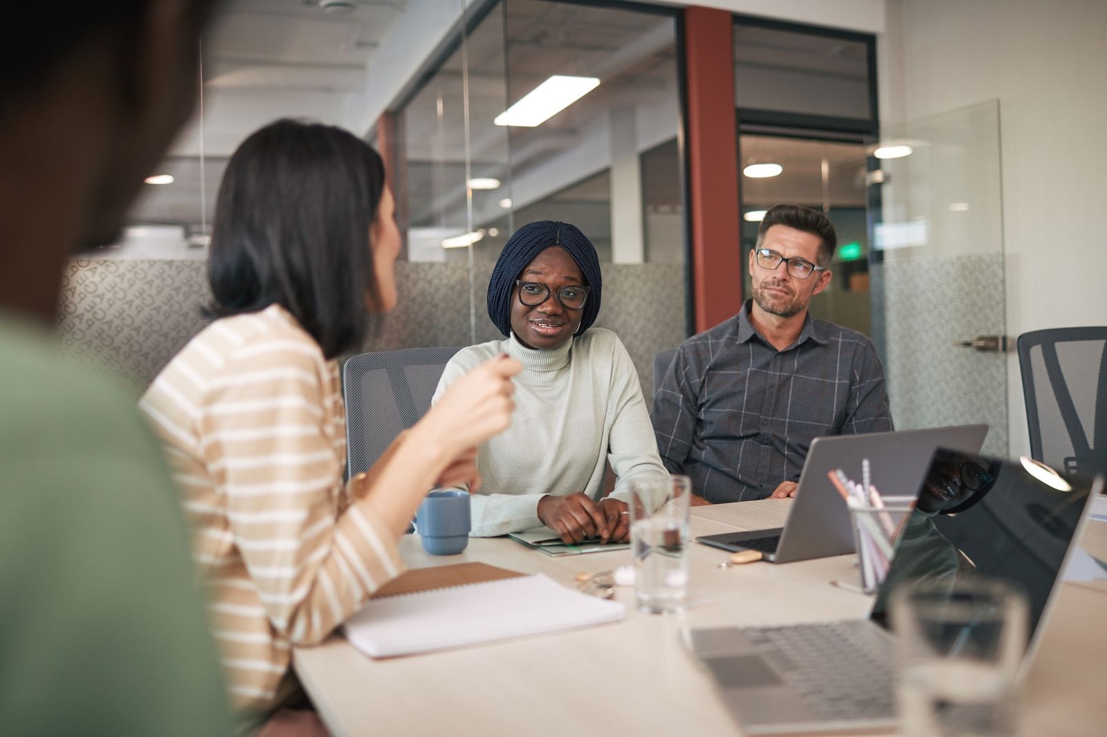A photo of a diverse group of people discussing AI ethics in a workshop setting. — AI ethics debate
