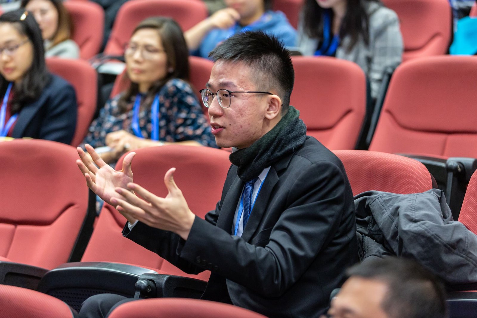 A photo of participants in a UBI trial discussing their experiences in the context of universal basic income debates.