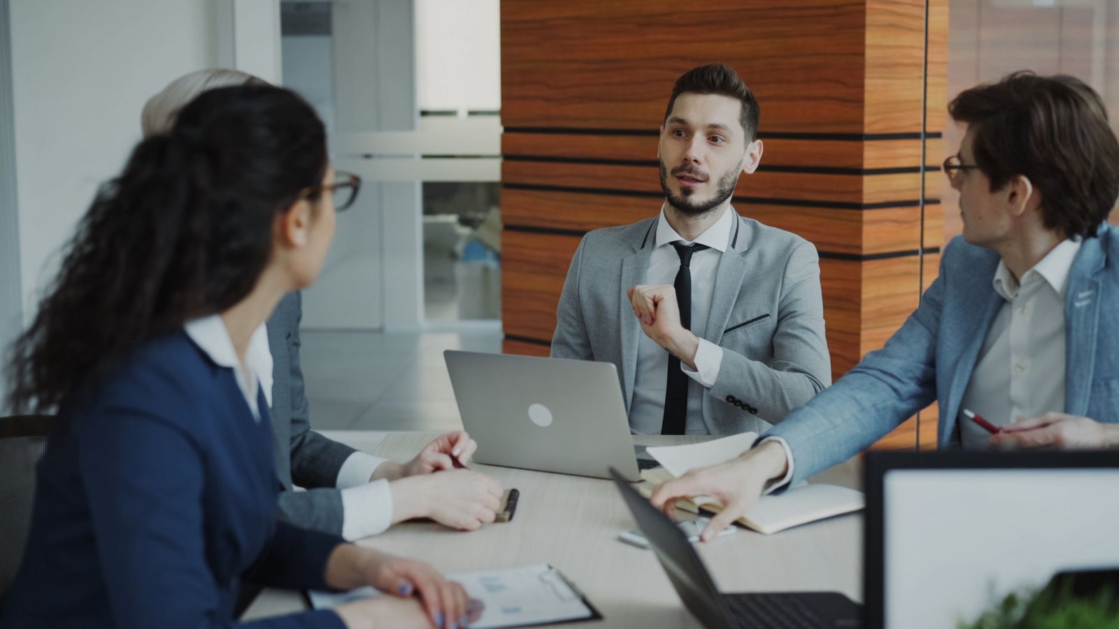 A professional engaging in a debate during a team meeting, showcasing effective communication. — debate skills for profe…
