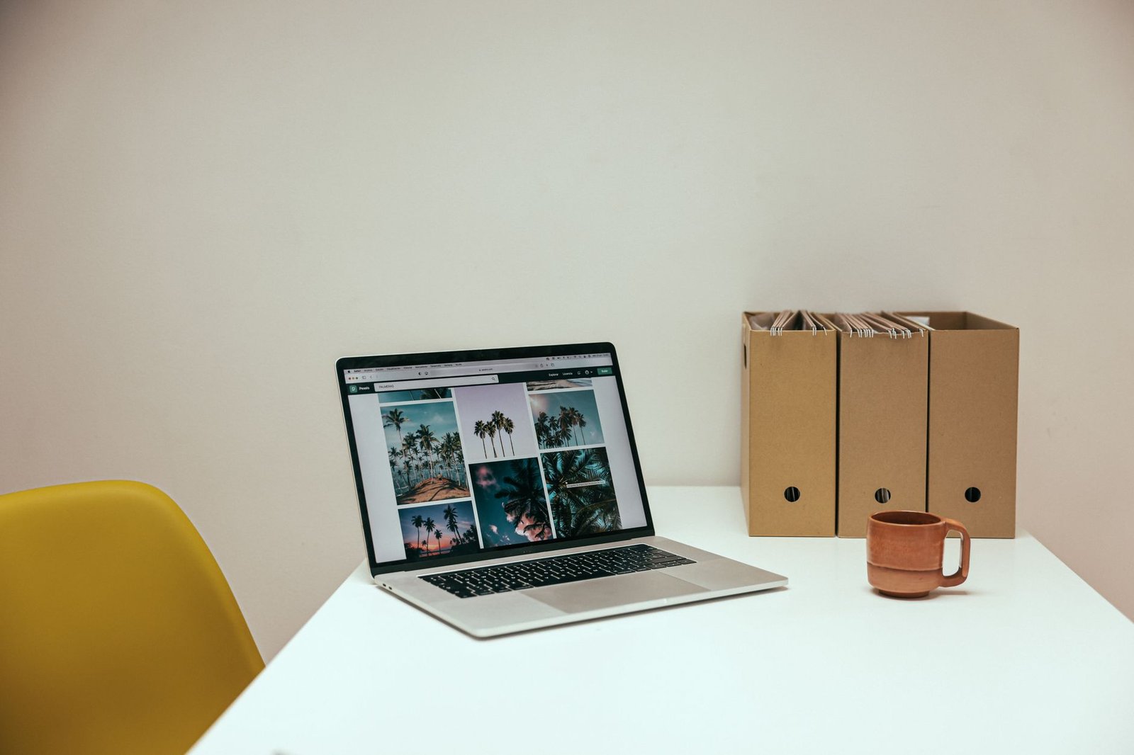 A split image depicting a comfortable remote workspace and a busy office environment. — future of work