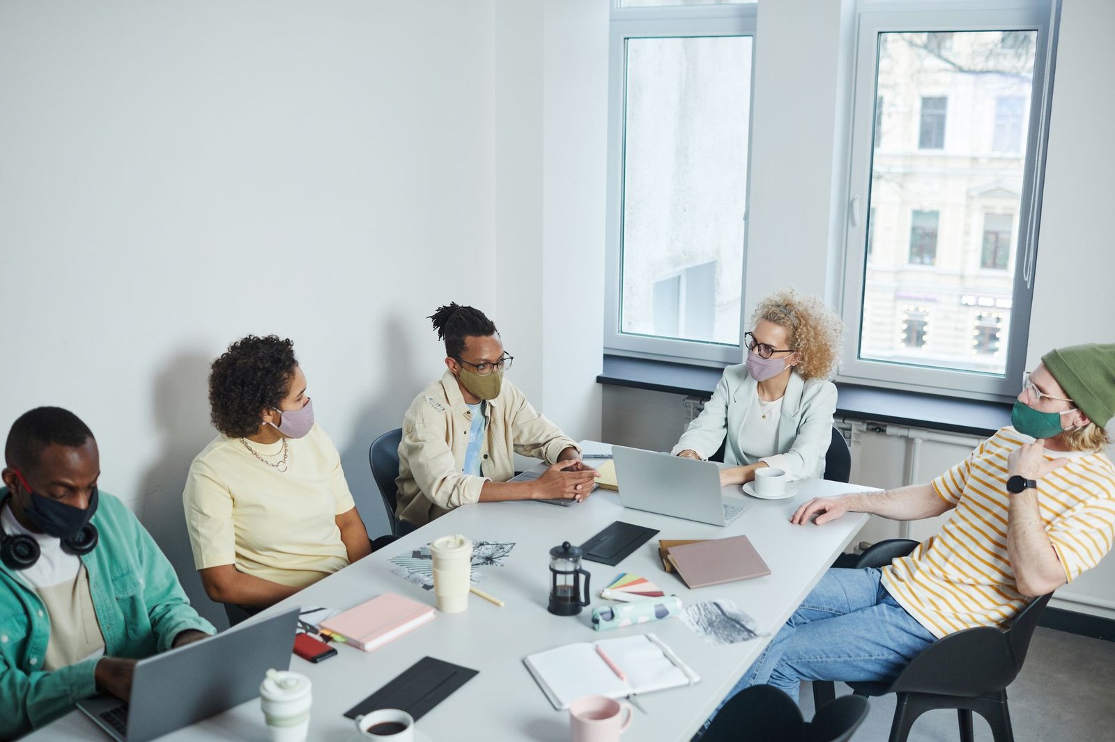 A visual representation of a hybrid work model with remote and in-office employees. — remote work debate