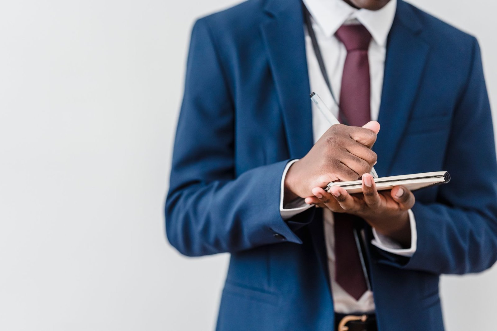 A close-up of a debater taking notes while listening to an opponent, emphasizing the importance of note-taking. — listen…