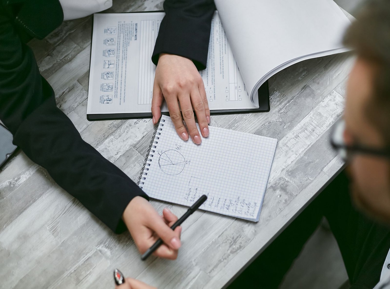 A close-up of a notepad with key debate strategies written down, illustrating preparation for a workplace discussion. — …