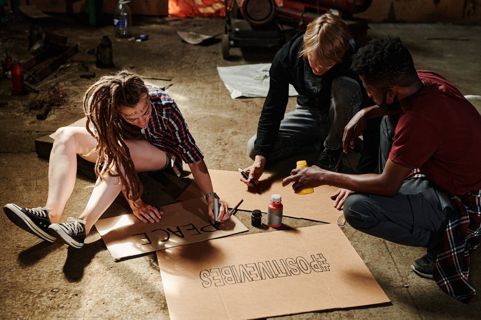 A community art workshop where participants create banners for a local protest, showcasing engagement through artistic exp…