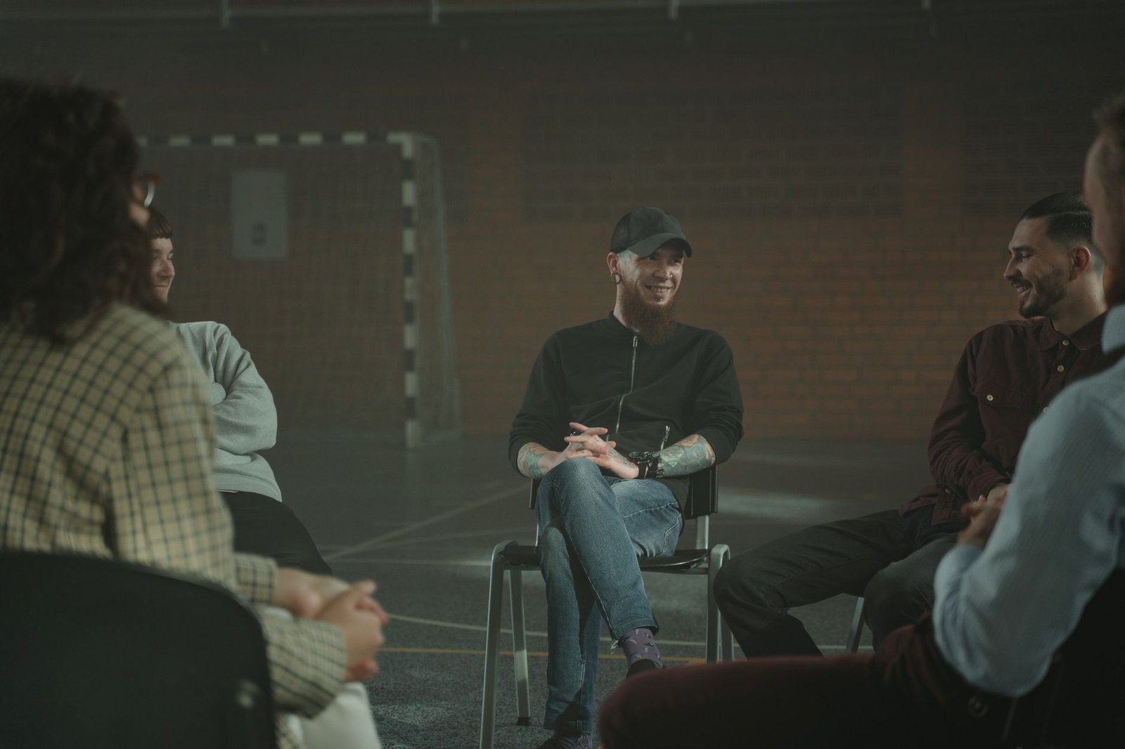 A group of people engaged in a calm discussion on sensitive topics, showcasing active listening and empathy. — sensitive…