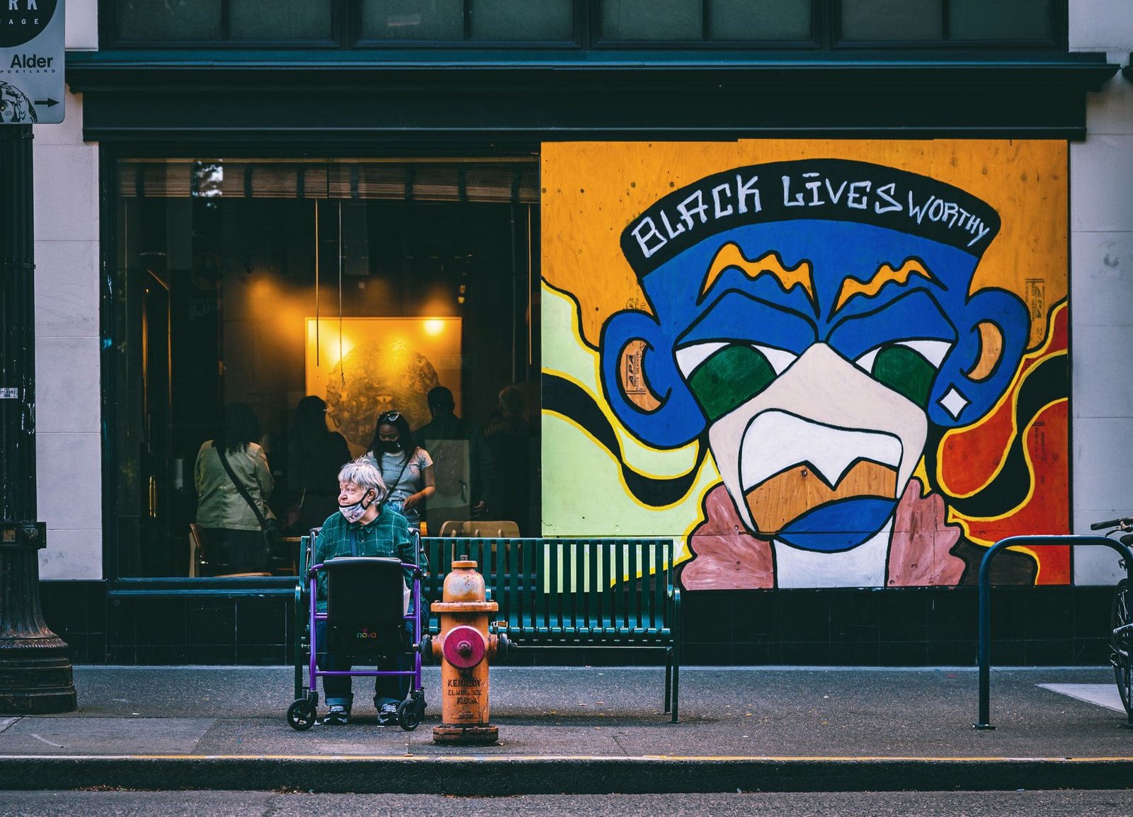 A mural depicting social justice themes in an urban setting, highlighting the intersection of art and activism.