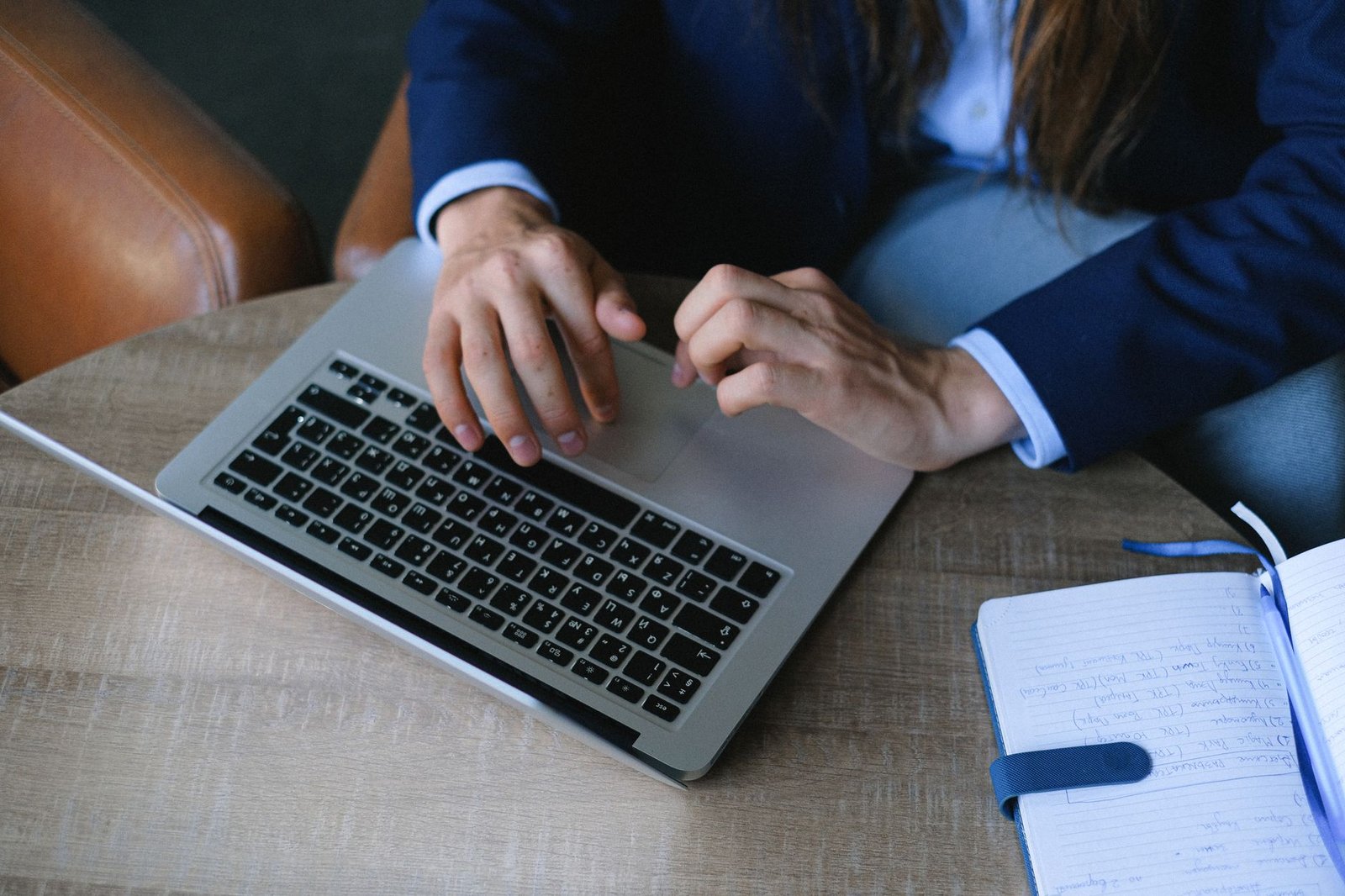 A person researching debate topics on a laptop, illustrating the research phase of debate preparation.