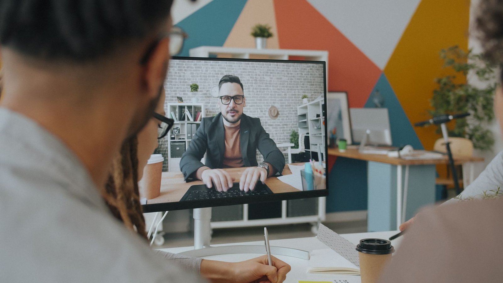 A photo of a diverse team collaborating via video conferencing technology. — future of work