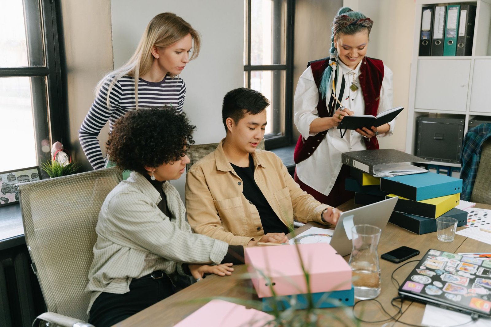 A photograph of a diverse group of developers discussing ethical AI practices in a meeting. — AI ethics