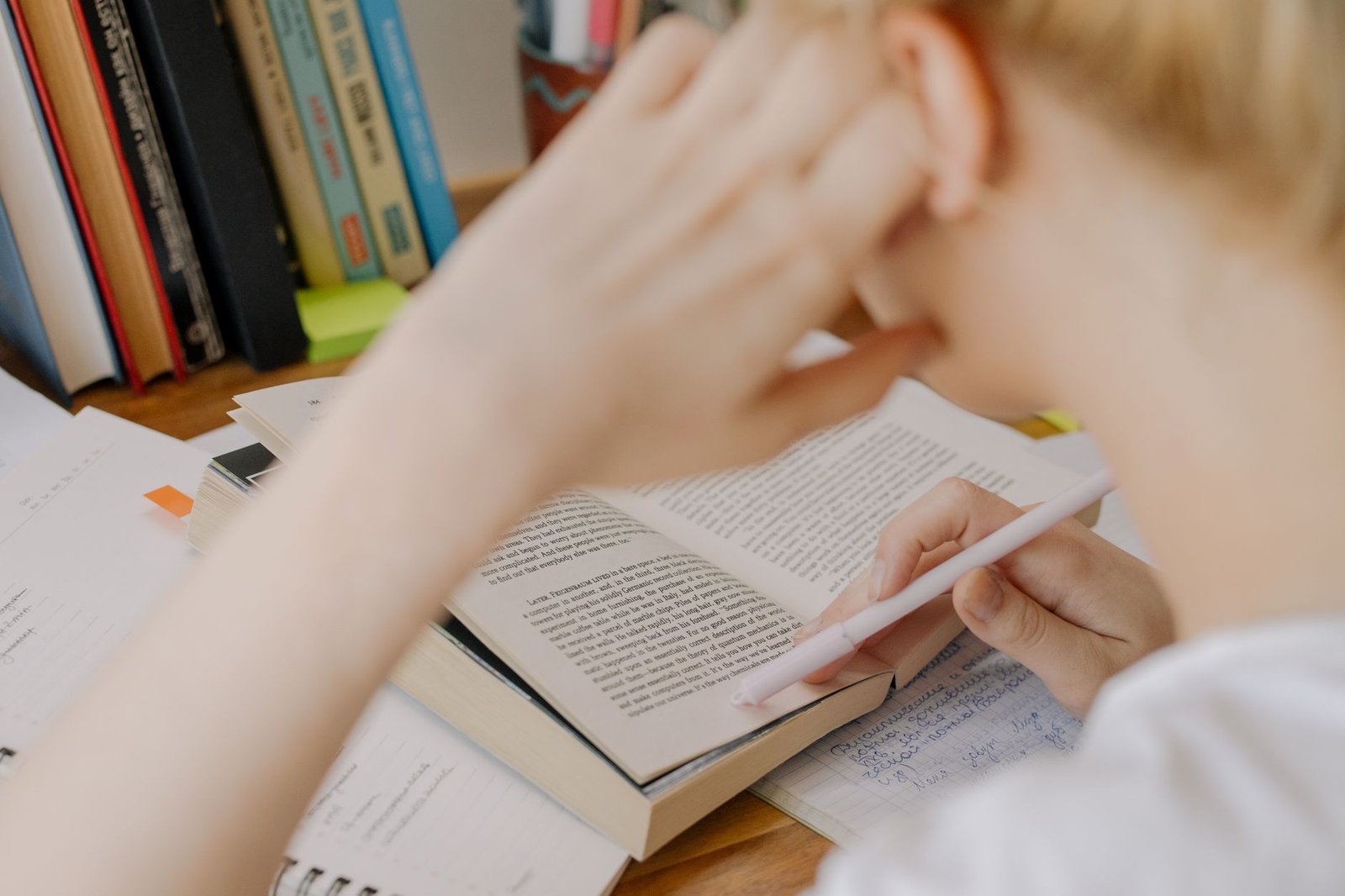 An organized study space with books and notes related to debate preparation.