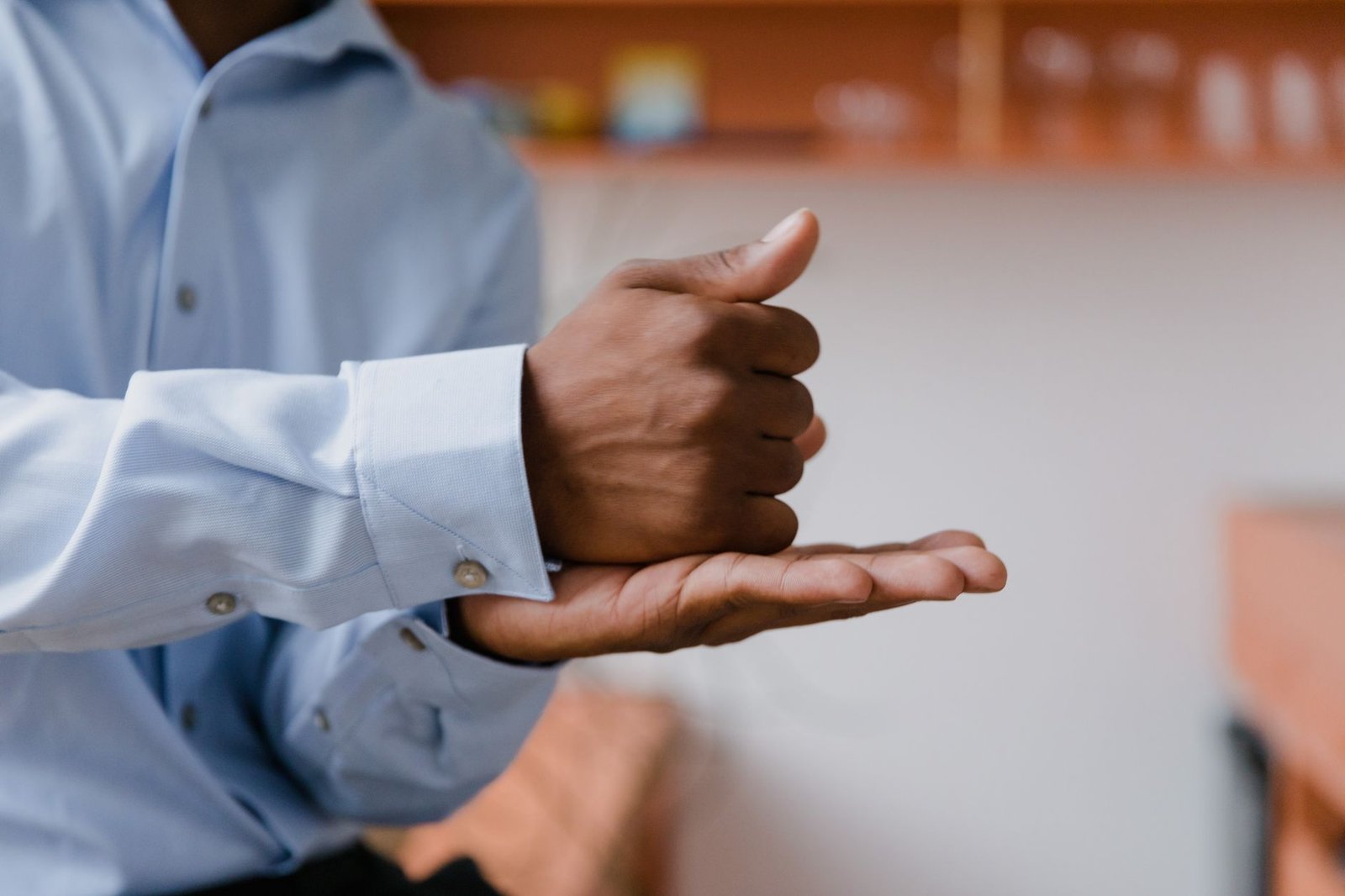 A close-up of a speaker using effective body language during a debate, emphasizing non-verbal communication with relevant debate preparation tips.