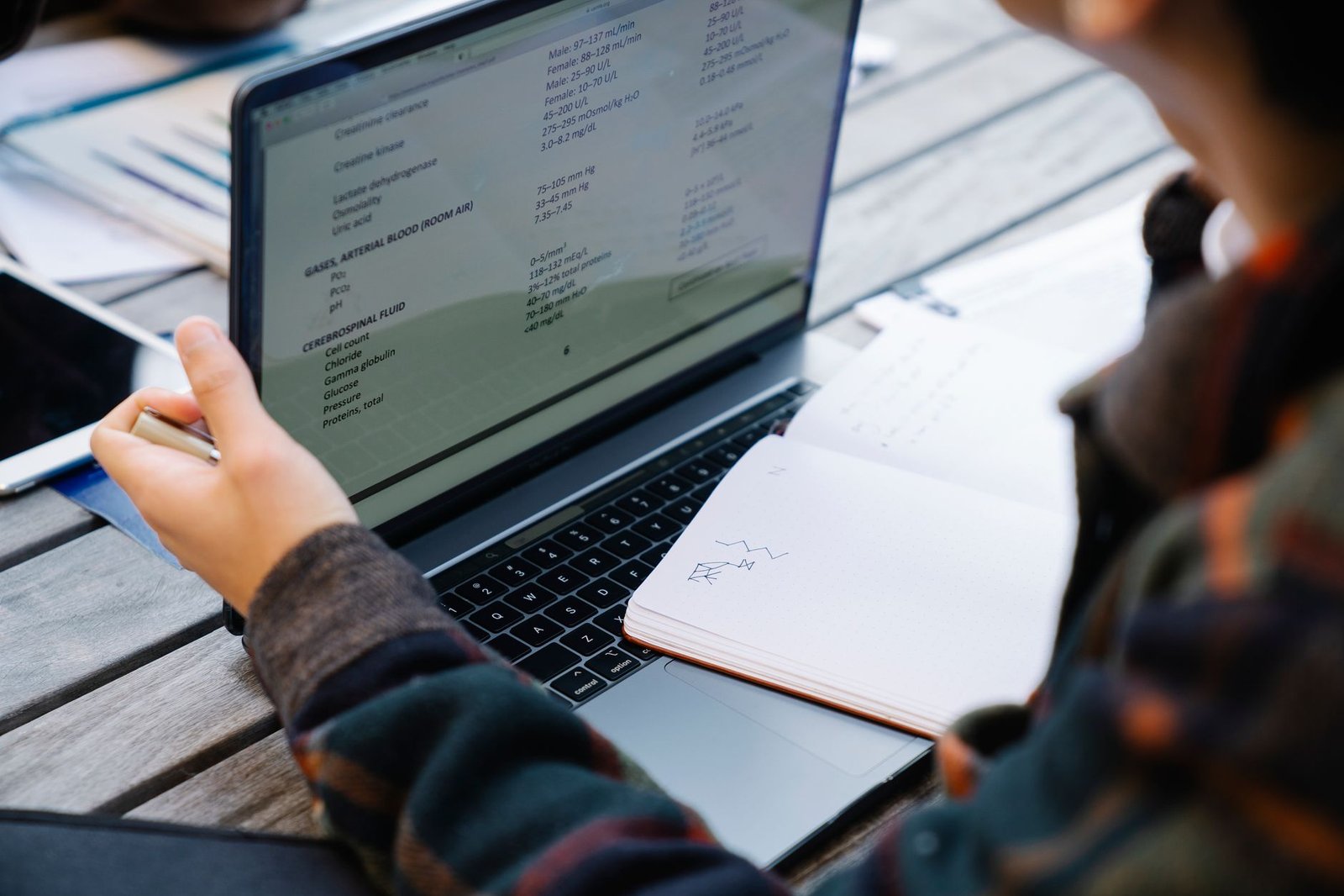 A close-up shot of a student researching debate topics on a laptop.