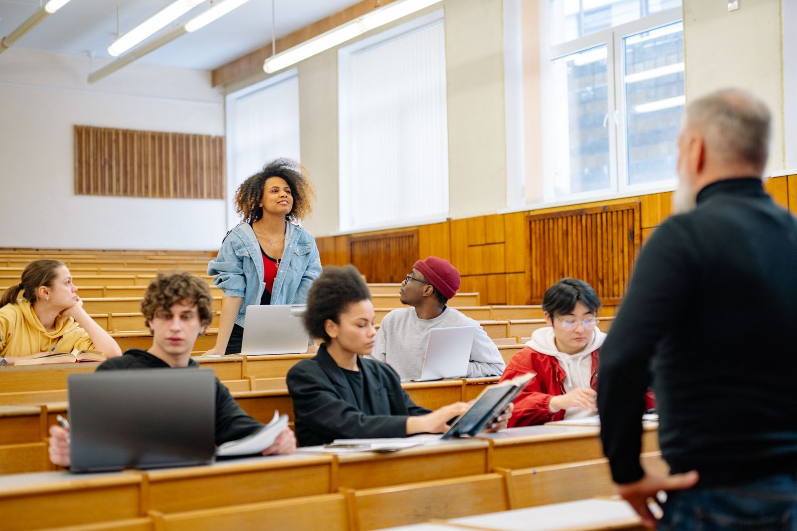 A diverse group of students engaged in a mock debate setting, showcasing active participation. — organizing mock debates
