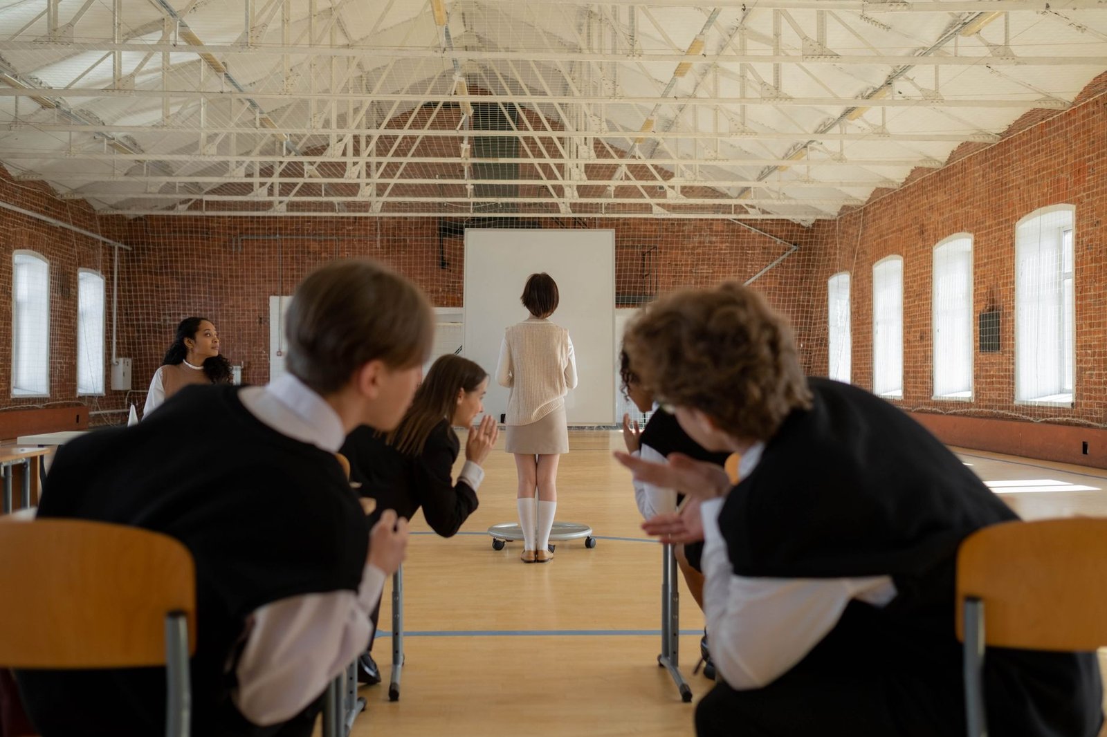 A group of peers practicing a debate in a classroom setting. — debate research strategies