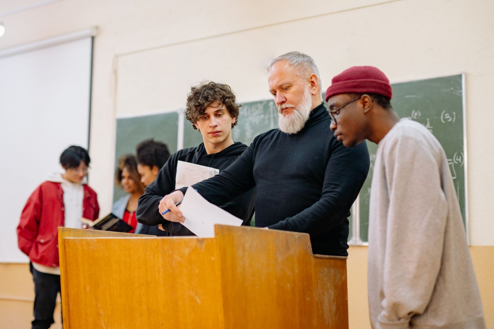 A group of students passionately debating at a podium in a classroom setting. — debate topics