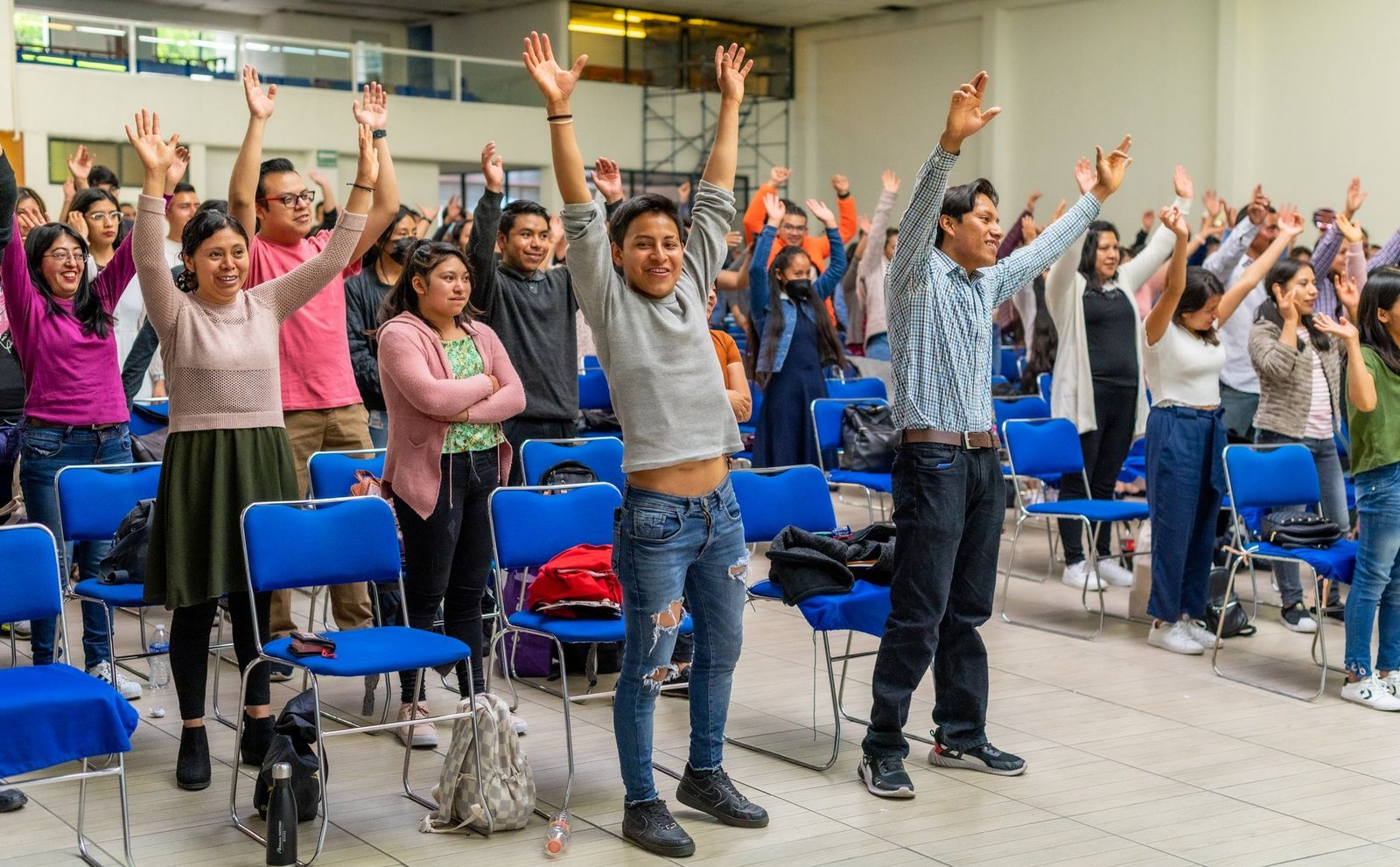 A photo of a diverse audience reacting positively to humor in a debate setting. — humor in debates