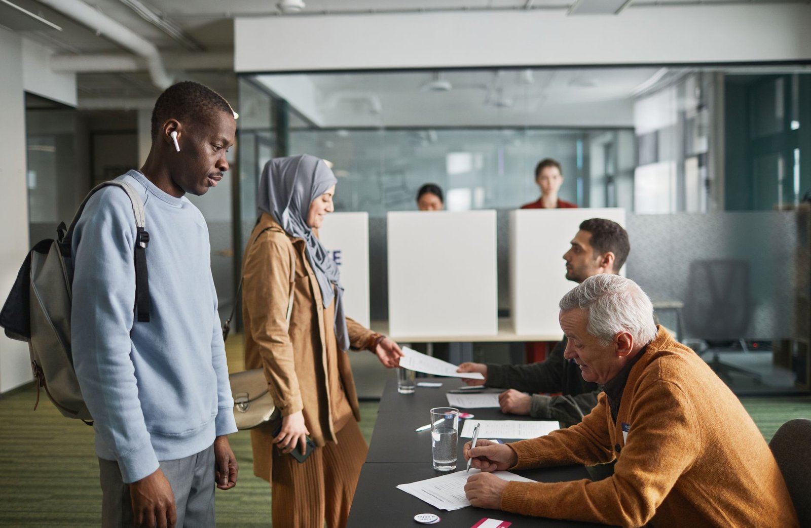 A photo of a diverse group of citizens casting their votes in an election, symbolizing democracy. — mandatory voting pro…