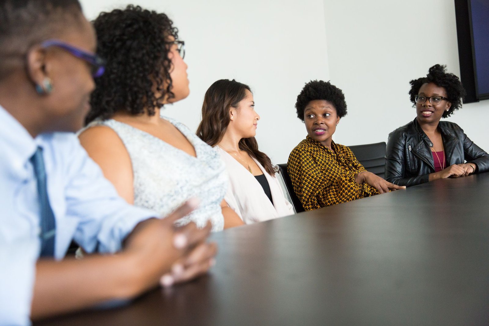A photo of a diverse group of people engaged in a discussion about technology and society. — technology ethics debate