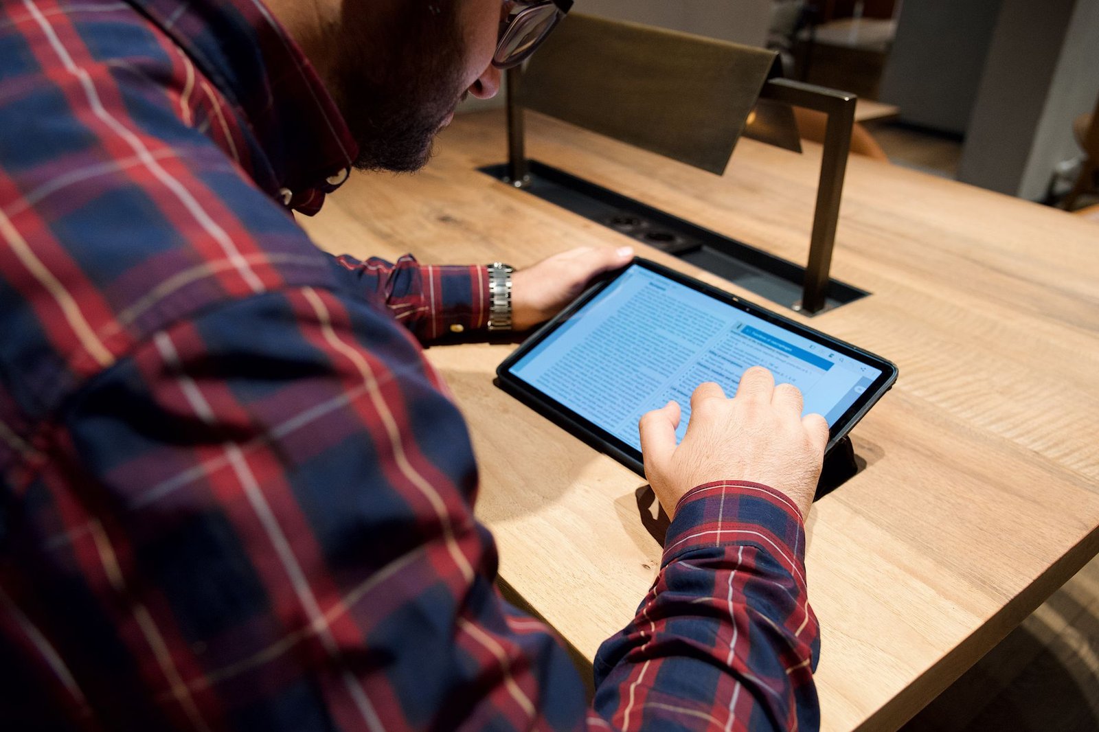 A photo of a person using a tablet to study, highlighting the positive use of technology in the technology impact debate.