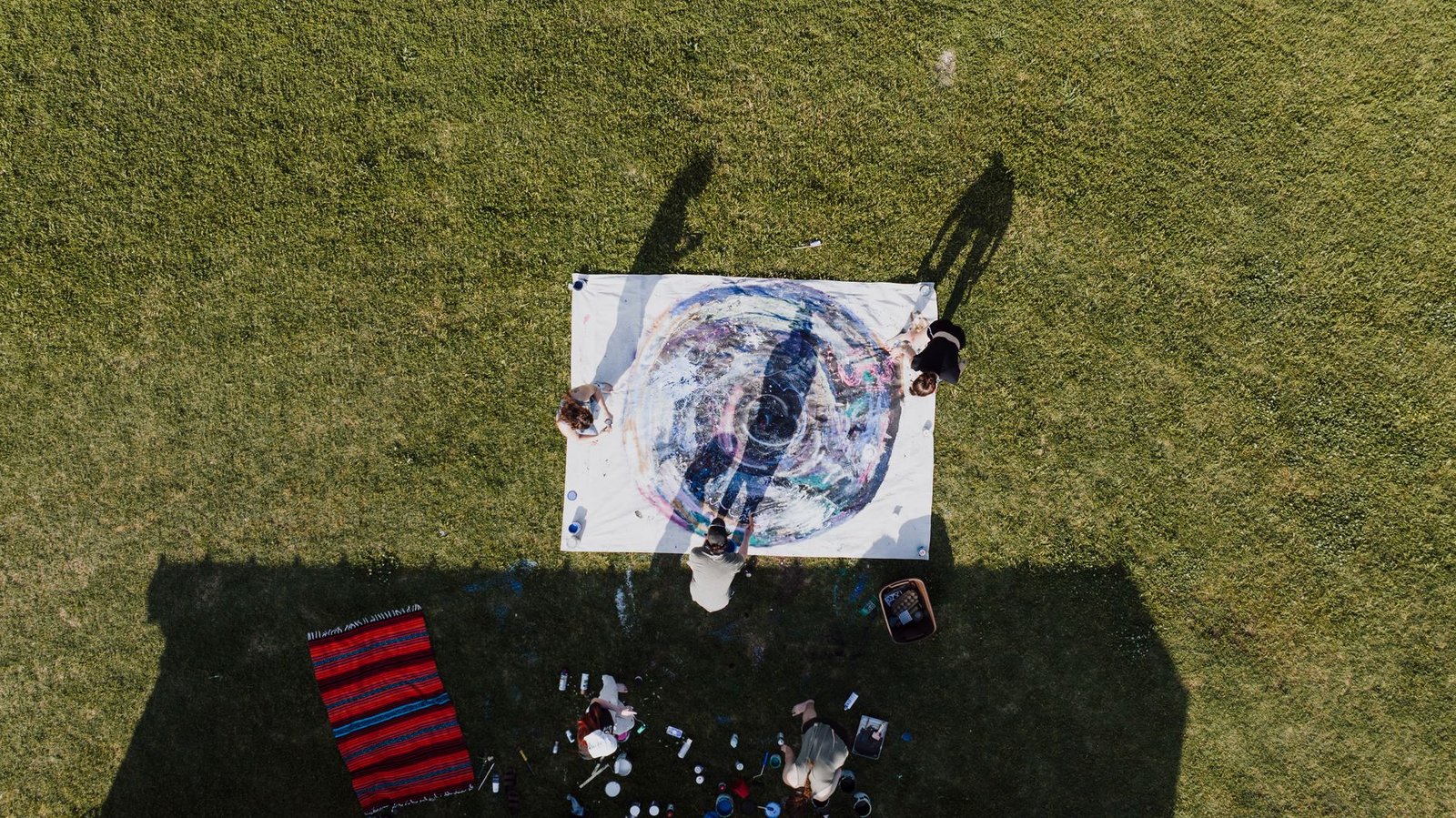 A photograph of a community art project where local residents collaborate on a large canvas. — art and activism