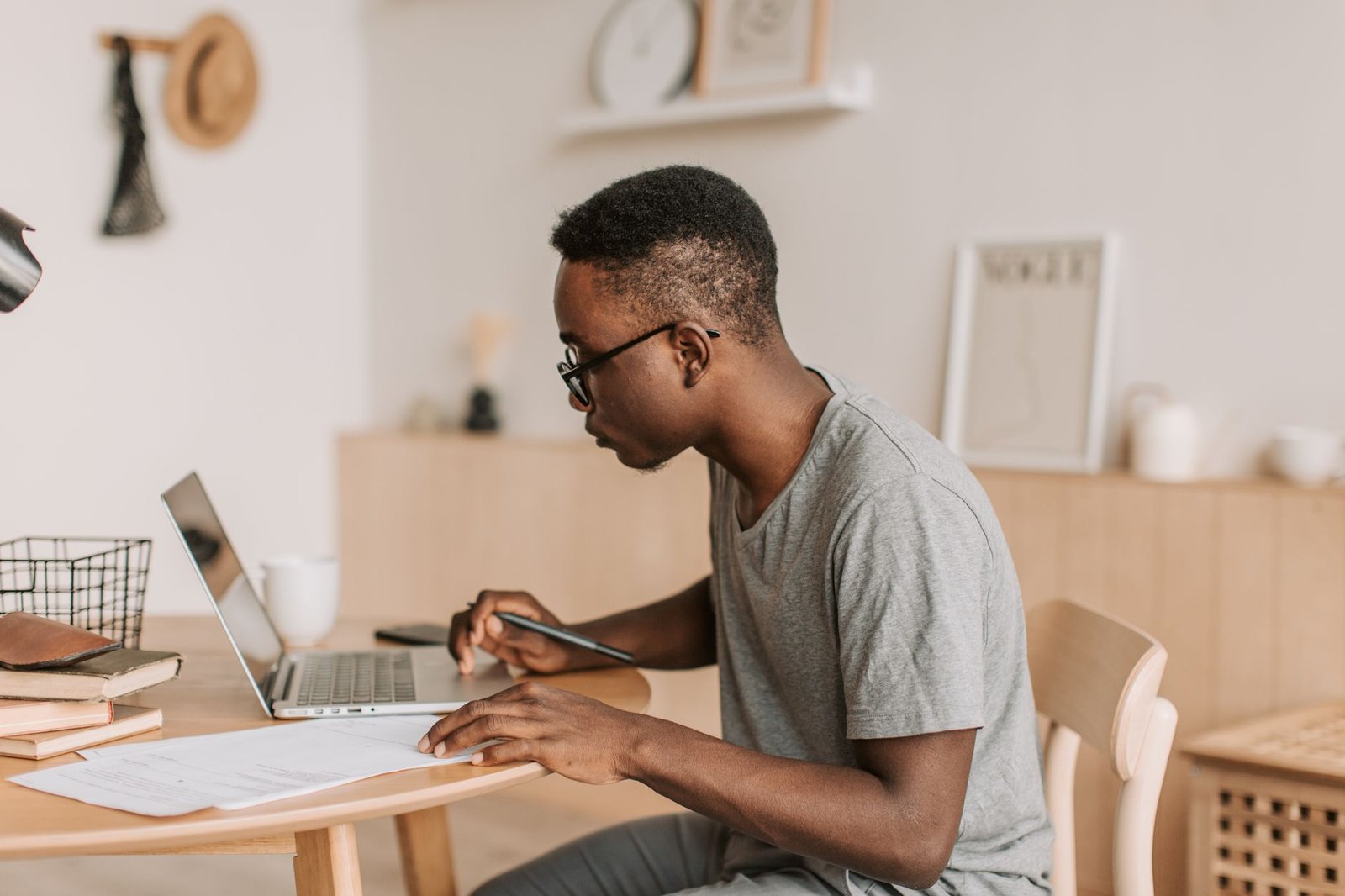 A photograph of a student studying from home using a laptop. — online education debate