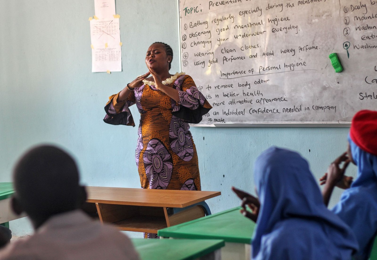 A teacher discussing mental health topics with students in an interactive session. — mental health education debate