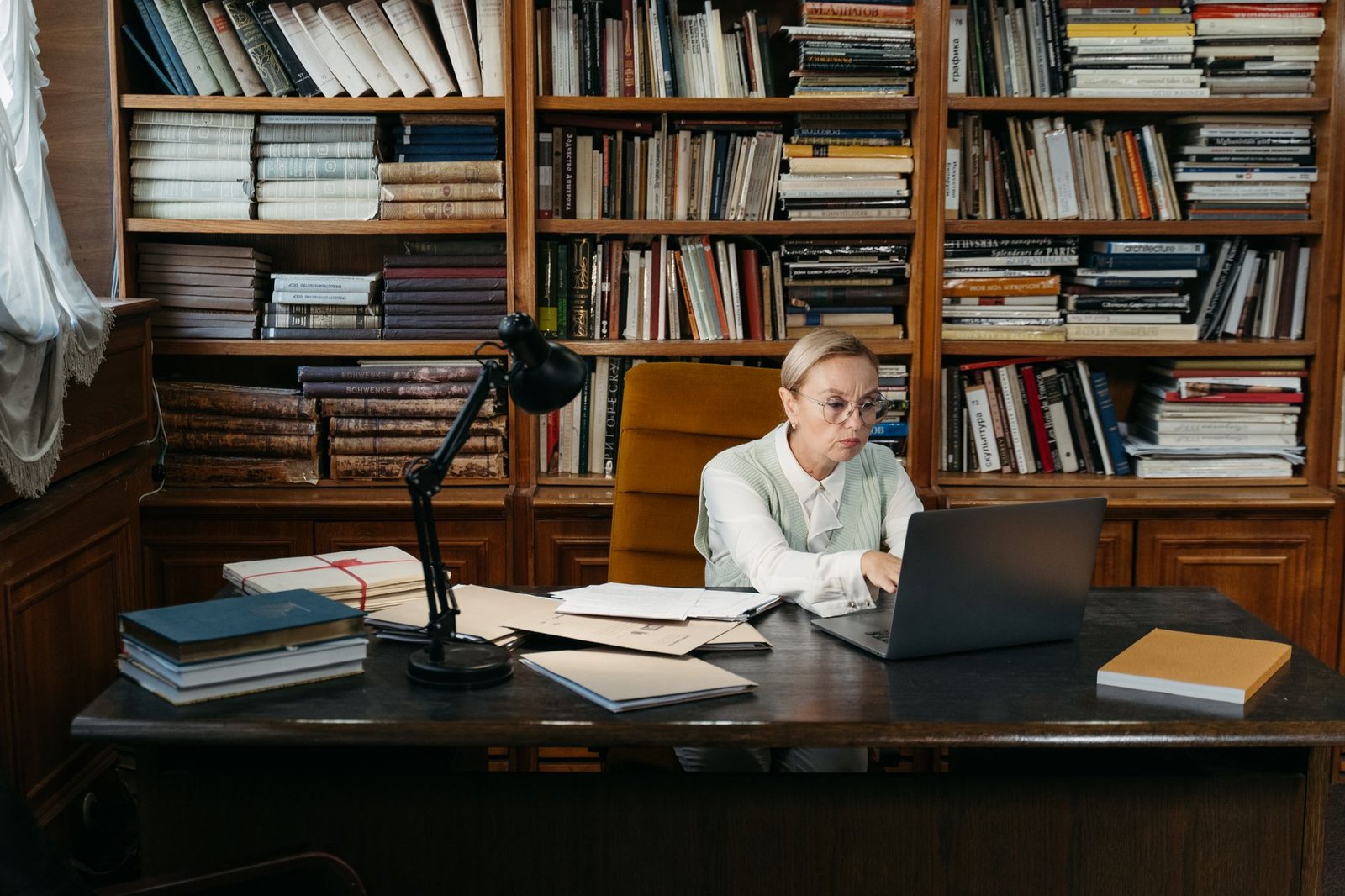 A well-organized desk with research papers and books for debate preparation.