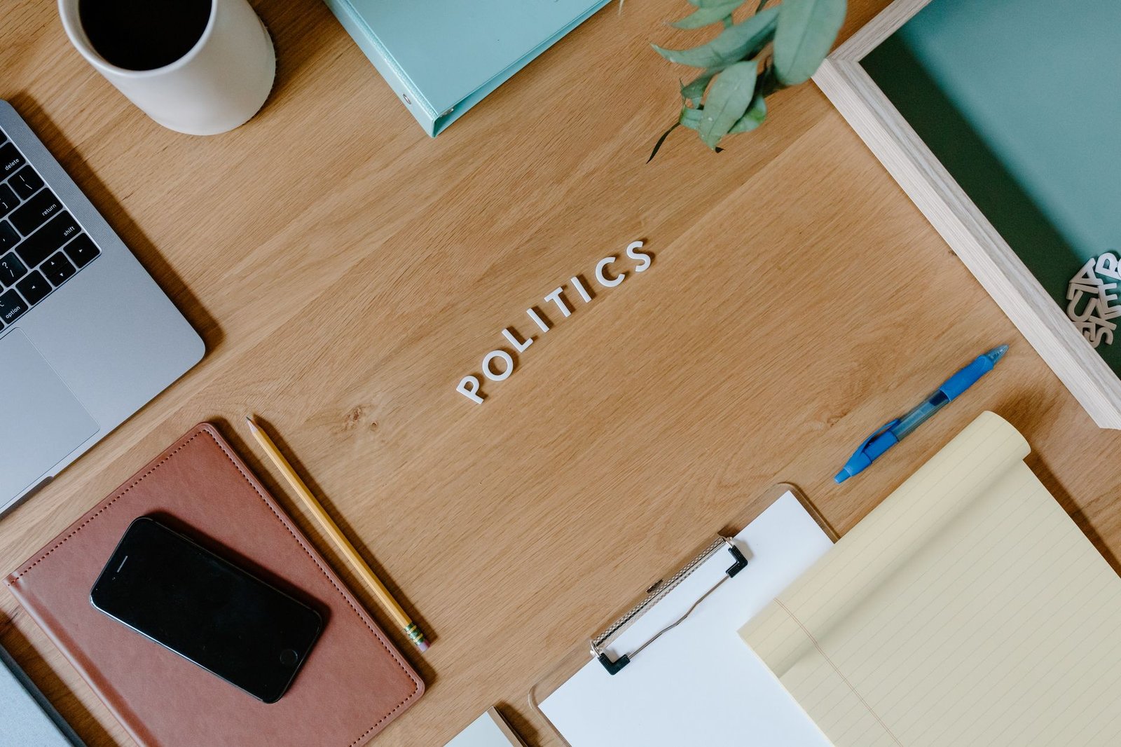 An organized table with debate materials, including notepads and timers, representing a structured debate environment. —…