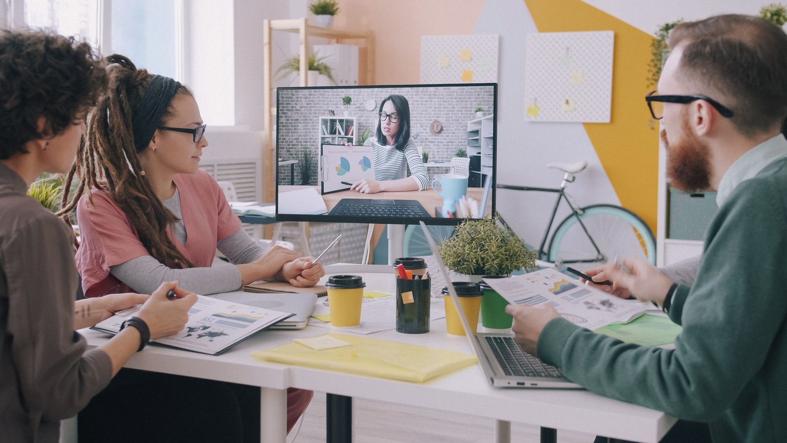 Image of a remote team collaborating over a video conference call, with diverse members engaged and sharing ideas. — rem…